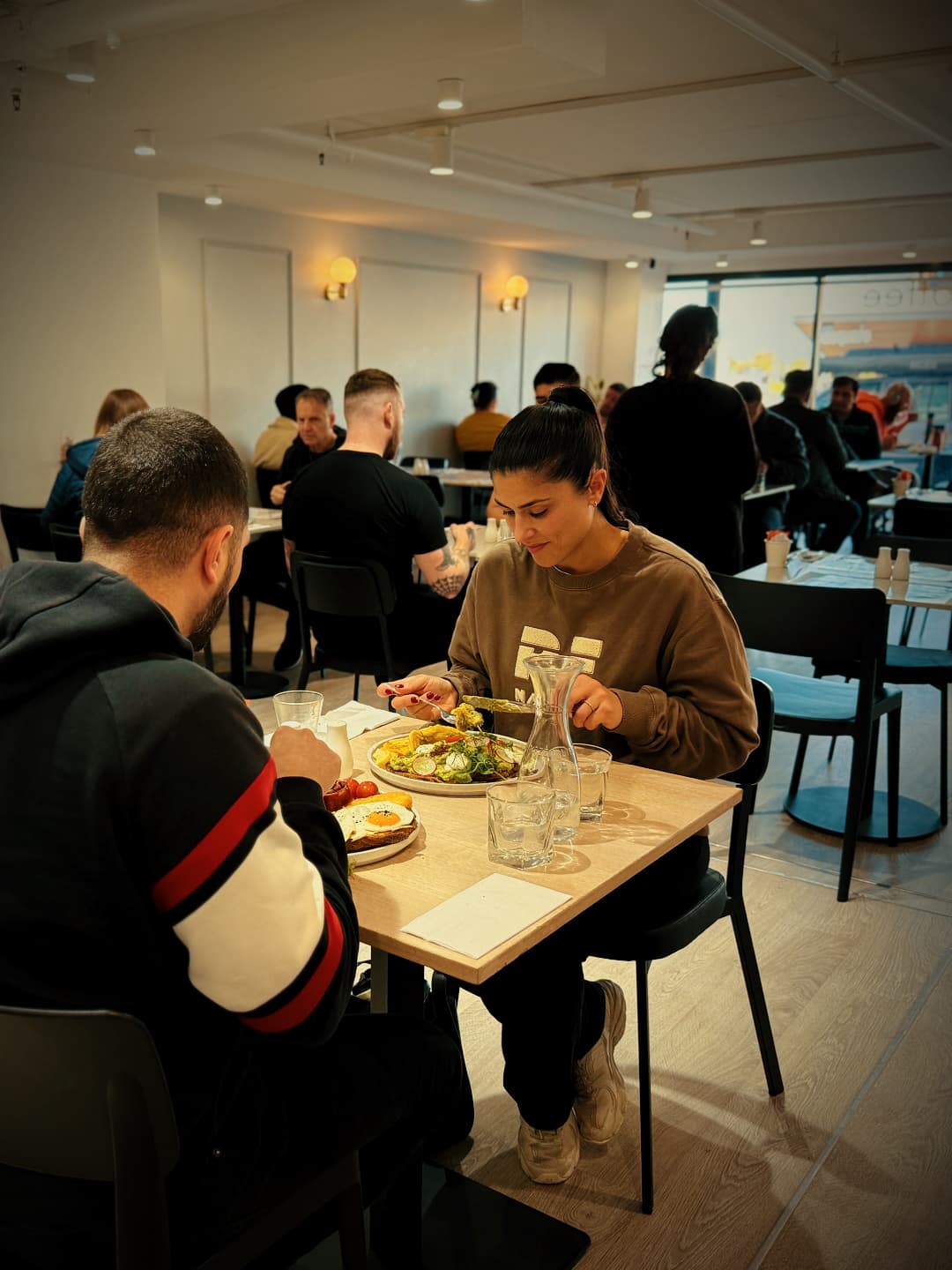 Customers enjoying breakfast inside the busy dining area at No9 The Cafe.